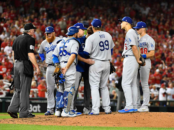 L.A. Dodgers players hang around the mound